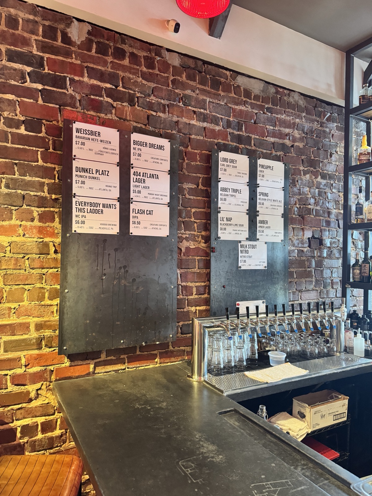 House beer boards above the bar's tap wall